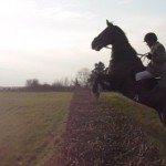 Campell Smith leaps the hedge on Diamond