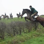 Huntsman Lee Johnston clears the hedge on Big Al