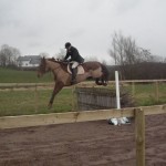 Hunt Master Philip White in flight over one of the gallop fences