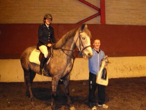 Roisin Donnelly and Ria receiving 1st place prizes for 1.10 class from Colm McCullagh, Ecclesville Manager