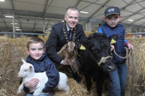 John Bamber, RUAS President with two new cattle breeds at Balmoral Show, Dexters and Irish Moiled. Pictured with his Dexter Cow is Nathan Tumelty (10) and Valerie Orr with an Irish Moiled. Photo by Aaron McCracken/Harrisons