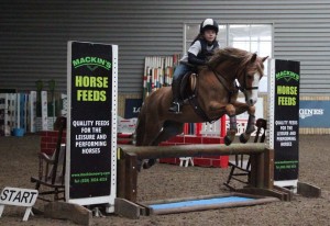 Georgia Kirkwood & Maddie on a flier over the Mackins Horse Feeds joker fence at the indoor arena eventing league at Ravensdale Lodge on Saturday.