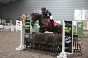 85cm class winners Judy Mc Nally & Zebedee take a flier over the joker fence at the Mackins Horse Feeds indoor arena eventing league at Ravensdale Lodge on Saturday.