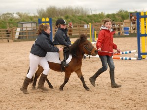 Emma Berry riding Betty Boo receives a helping hand from sister Sian and friend Hannah Agnew in the x pole class