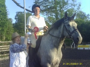 Noel Regan & Kallie winners of the 80cm class receiving the L W Surphlis & Son Perpetual Trophy from Mrs Mary Surphlis