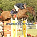 Flying over the fences to win the TRM / Horseware Premier Series GP at National Balmoral, Frank Curran and New World owned by Bovean Stables