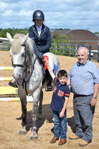 Niamh Donnelly peizewinner in the 1m class on Lynderry Action Girl. Presentation by Dylan Connell grandson of sponsor Authur O'Neill of O' Neill Tractors Culloville.