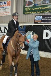 Emmet McCourt and Latika 1st prizewinners in the 1.10m class. Presentation by Mrs Prentice of David Prentice BMW