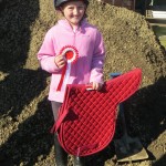 A delighted Lucy Gillespie winner of the 50cm class
