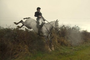 Eamon O'Connor taking aflyer over a hedge 
