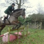 Hunt Master Ian Holmes on Pancho clear the barrel and plank