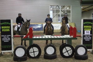 Recently married Jim & Emma Newsam both go clear in the 1m class at the Mackins Horse Feeds indoor arena eventing league at Ravensdale Lodge on Saturday. Pictured in front of the Mackins Horse Feeds joker fence they are joined by Rosalyn Brown (centre) who also went clear.