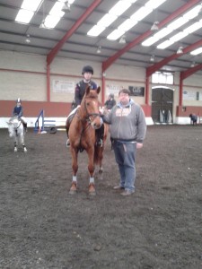 chris bogle judge presenting emma boyd & jazzy with their double clear rosette in the 90cm class; they also drew 1st prize - a bale of bluefrog shavings very kindly sponsored by Raymond Boyd