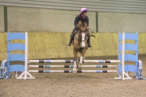 Lisa Neville & Chelsea in action over the 80cm track at Ravensdale Lodge's horse & pony training league on Friday night. Photo: Niall Connolly.