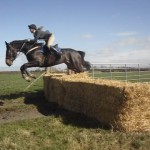 Hannah Patterson flies over the big bale