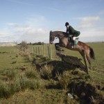 Huntsman Jonny clearing the fence on Tyra