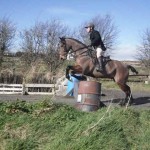 Simon Carson on Ace clearing the fence