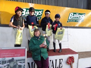 Judy Maxwell of BAILEYS HORSE FEEDS presents Wallace High Flyer cup and prizes to winning team - Dromore High Flyers L-R Sarah Topley, Zoe Gilliland, Hannah Agnew, Victoria Boville.