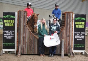 85cm arena eventing class league & final winner Kate Kenwright is presented with her prizes from Linda Mackin from sponsors Mackins Horse Feeds. Also in photo is John Downey & Smitty who were second in the class and Ethan Smith & Bluestone Ice who were third. Photo: Niall Connolly.