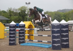 Gerard Clarke recorded back to back wins at Ravensdale Lodge's Longines National Grand Prix. Clarke, pictured jumping the Longines Oxer, recorded his victory in the 2014 renewal on board Eugene Hanratty's Woodprins. Photo: Niall Connolly.