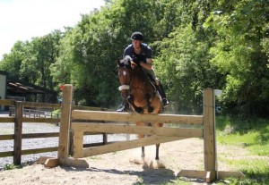 Producer and rider Ciaran Thompson, seen here with Lucy jumping the barrier fence in the new all-weather "sand chute" at Ravensdale Lodge, had both his horses clear over the 1m track at the Moorhill Saddlery cross-jump series held at the centre on Sunday Photo: Niall Connolly.