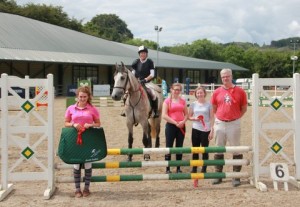 Amanda Telford (first left), who drew the lucky rosette to win the Moorhill Saddlery saddle pad is joined by Bronagh Stevenson (mounted), Hannah Rafferty, Kerrie Rafferty and Eric Brunton who all gained maximum four points in the 85cm class at Sunday's Moorhill Saddlery cross-jump series at Ravensdale Lodge: Photo: Niall Connolly 