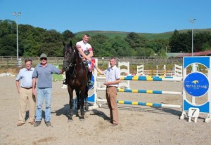 John Floody, pictured with winning owner Brian Kieran & Francis Hughes signed off on another successful SJI registered horse league at Ravensdale Lodge on Wednesday. Floody, seen here receiving his prize from course designer and SJI vice chairman Ray Buchanan on board HTS Blackrock was successful in the 1.10m, 1.20m & 1.30m finals and also picked up a leading rider prize for his efforts. Photo: Niall Connolly.