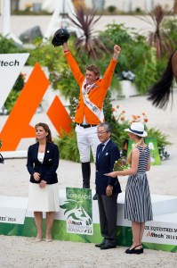 The Netherlands’ Jeroen Dubbeldam celebrates victory in the individual Jumping final after receiving the gold medal from IOC Member, Tsunekazu Takeda, Vice-President of the Tokyo 2020 Organising Committee and Member of the FEI Olympic Council, and FEI President, HRH Princess Haya. (Dirk Caremans/FEI)