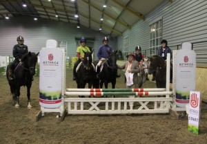 Sean Cooney of Warrenpoint based Botanica International makes a flying visit to Ravensdale Lodge on Friday evening to present 90cm clear rounds, Katie Creegan, Sinead Young, Anna Harvey, John Downey & Orla Moriarity with their rosette as title sponsor of the horse & pony training league. Photo: Niall Connolly.