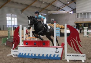 Ciara Muirhead and Hanslough put in a lovely jump over the Horse First Joker fence in the 1m class at the Horse First indoor arena eventing league at Ravensdale Lodge on Saturday afternoon Photo: Niall Connolly.