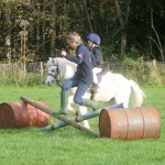 Kitty Cullen mastering the cross poles with the help of mum, Becky