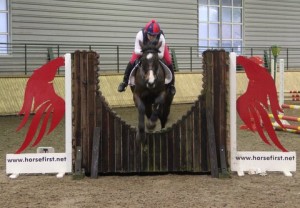 Emma Cochrane & Extract put in a fine jump over the sponsors joker fence in the 70cm class at the Horse First indoor arena eventing league at Ravensdale Lodge on Saturday afternoon. Photo: Niall Connolly.
