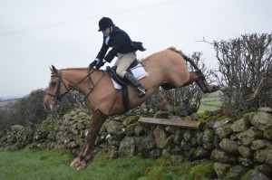 Brendan Doherty in flight over the last fence of the day