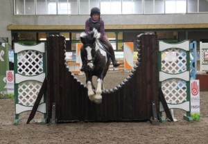Janet Cooke & Louis Two Tone clear the joker fence in the 70cm class at Ravensdale Lodge's indoor arena eventing league on Saturday afternoon. Photo: Niall Connolly.