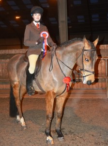 Champion Pony "Fizz" and Ciara Lane pose with their rosettes