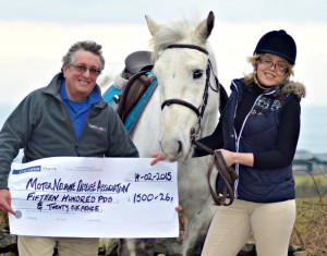 Roisin McGinn, along with horse Jake, is pictured presenting the cheque to Stephen Thompson from the Motor Neurone Disease Association. Photo: Karenann Toney Photography, Ballycastle