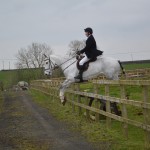 Eamon O'Connor on Oppie in flight over the ranch fence