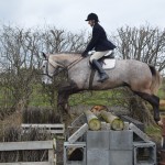 Lesley McDowell on Charlie in flight over the gallop logs