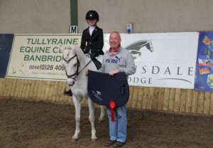 "What a pretty picture", judge David Patterson presents class 4 league winners Vicky Campbell & Dennis The Menace with their prizes at the final of the winter / spring indoor dressage league at Ravensdale Lodger on Sunday. Photo: Niall Connolly.