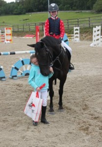 "Smiles all round" Tucker gets a big hug and kiss from Caoimhe Traynor after finishing second in the 90cm class when ridden by sister Ava at Ravensdale Lodge's "bumper" bank holiday show on Sunday. Photo: Niall Connolly.