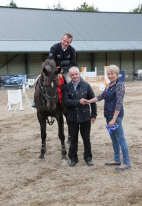 Winning owner, John Downey, is presented with his prize by judge Eilish Mulholland after his horse "Away Again" won the hotly contested 1.10m class under regular rider John Floody at Ravensdale Lodge's SJI registered horse league finals on Wednesday afternoon. Photo: Niall Connolly.